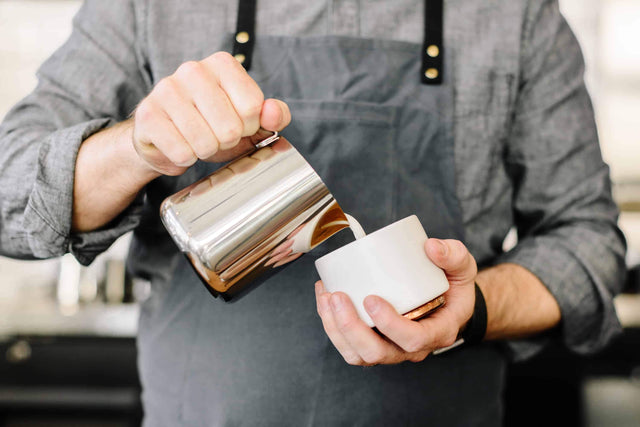 Fellow Eddy milk steaming pitcher pouring latte art in a Fellow Monty cappuccino cup, Clive Coffee - Lifestyle