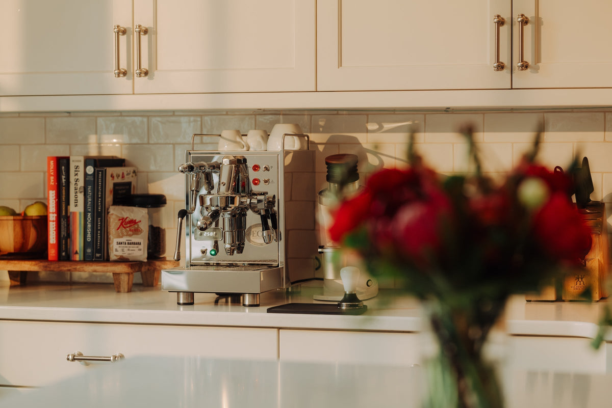 ECM Classika PID espresso machine on a kitchen counter with a blue gauge and chrome fittings