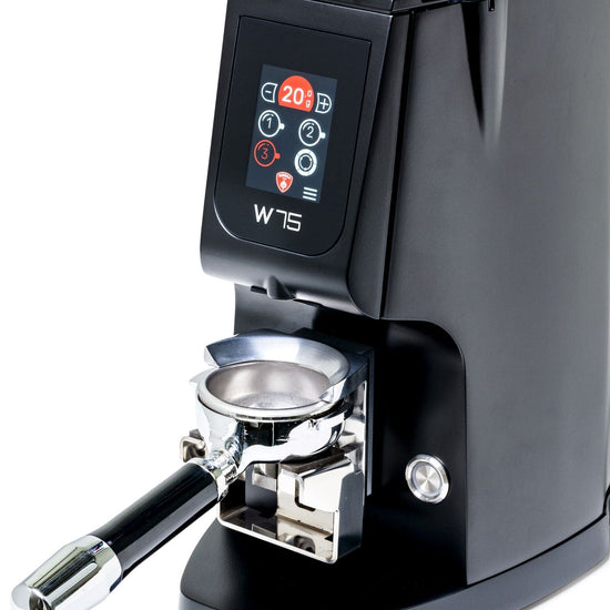 Close-up of the Eureka Atom W75 espresso grinder front panel with a digital display and a portafilter attached