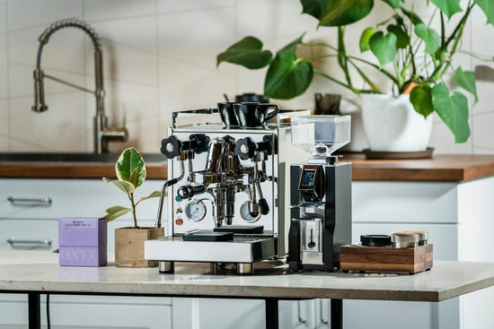 Airscape coffee canister with a wooden lid on a kitchen counter beside a sleek espresso machine.