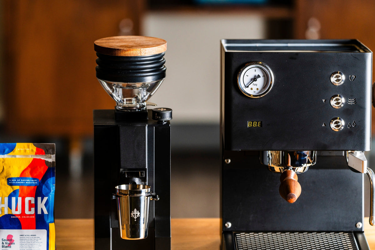 LUCCA Tempo espresso machine on a wooden counter with wooden portafilter and front gauge