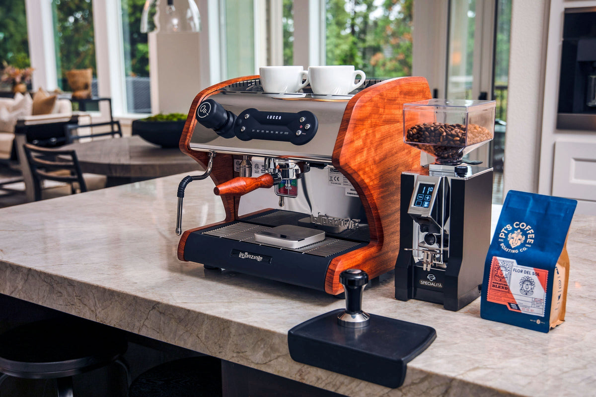 LUCCA A53 Direct Plumb espresso machine with two white cups on top and a clear bean hopper beside it