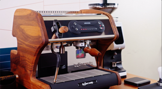 Front view of LUCCA A53 Mini V2 espresso machine with wood side panels and a control dial