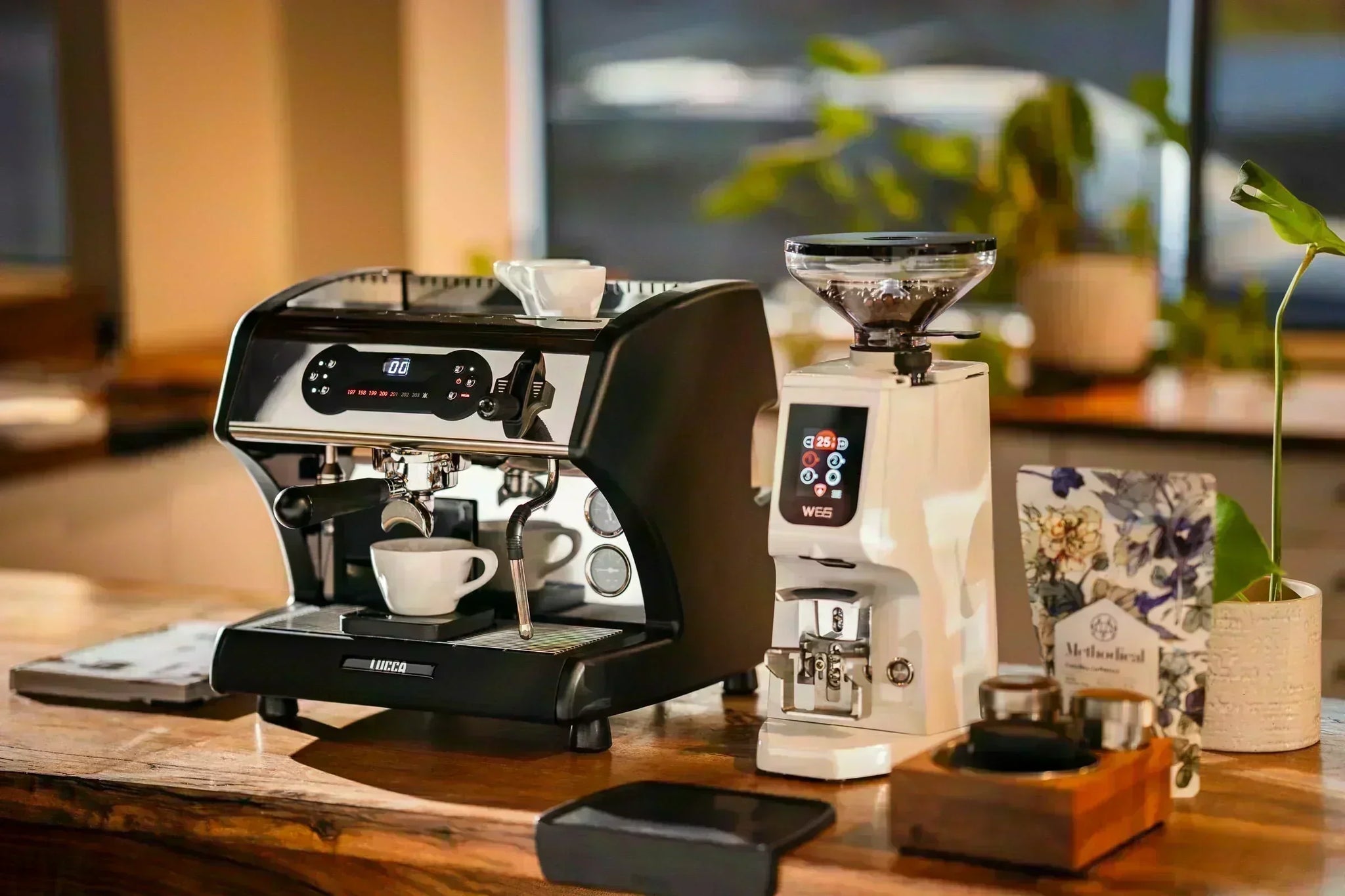 LUCCA A53 Pro Espresso Machine next to the Eureka Atom W 65 Espresso Grinder Lifestyle by Clive Coffee