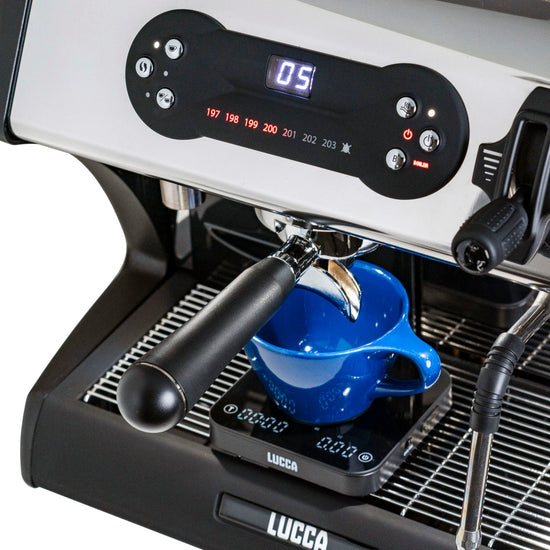 Close up of a LUCCA espresso machine control panel with a digital display reading 05 and a blue cup under the portafilter