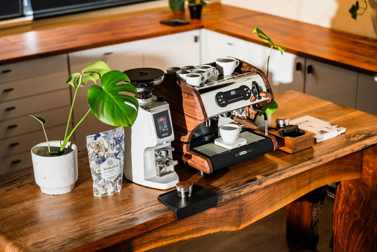 LUCCA A53 Pro espresso machine with wooden housing on a wooden counter and cups on top