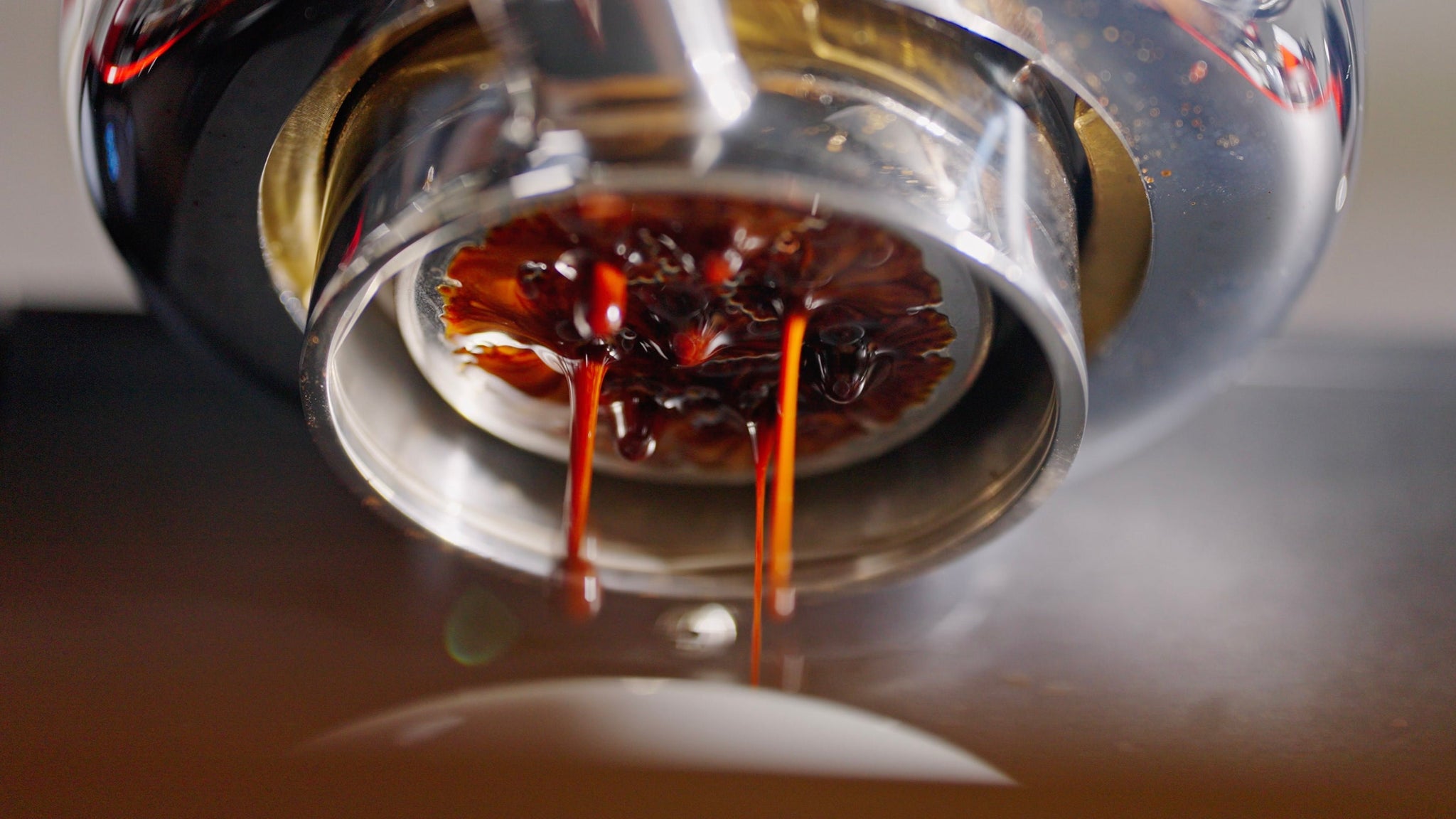 Overhead view of a white espresso cup with crema on a digital kitchen scale.