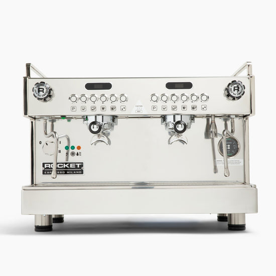 Rocket Espresso Milano dual group espresso machine with chrome housing on a kitchen counter.