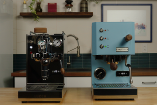 Two espresso machines side by side on a wooden counter, LUCCA Solo on the left and Profitec GO on the right