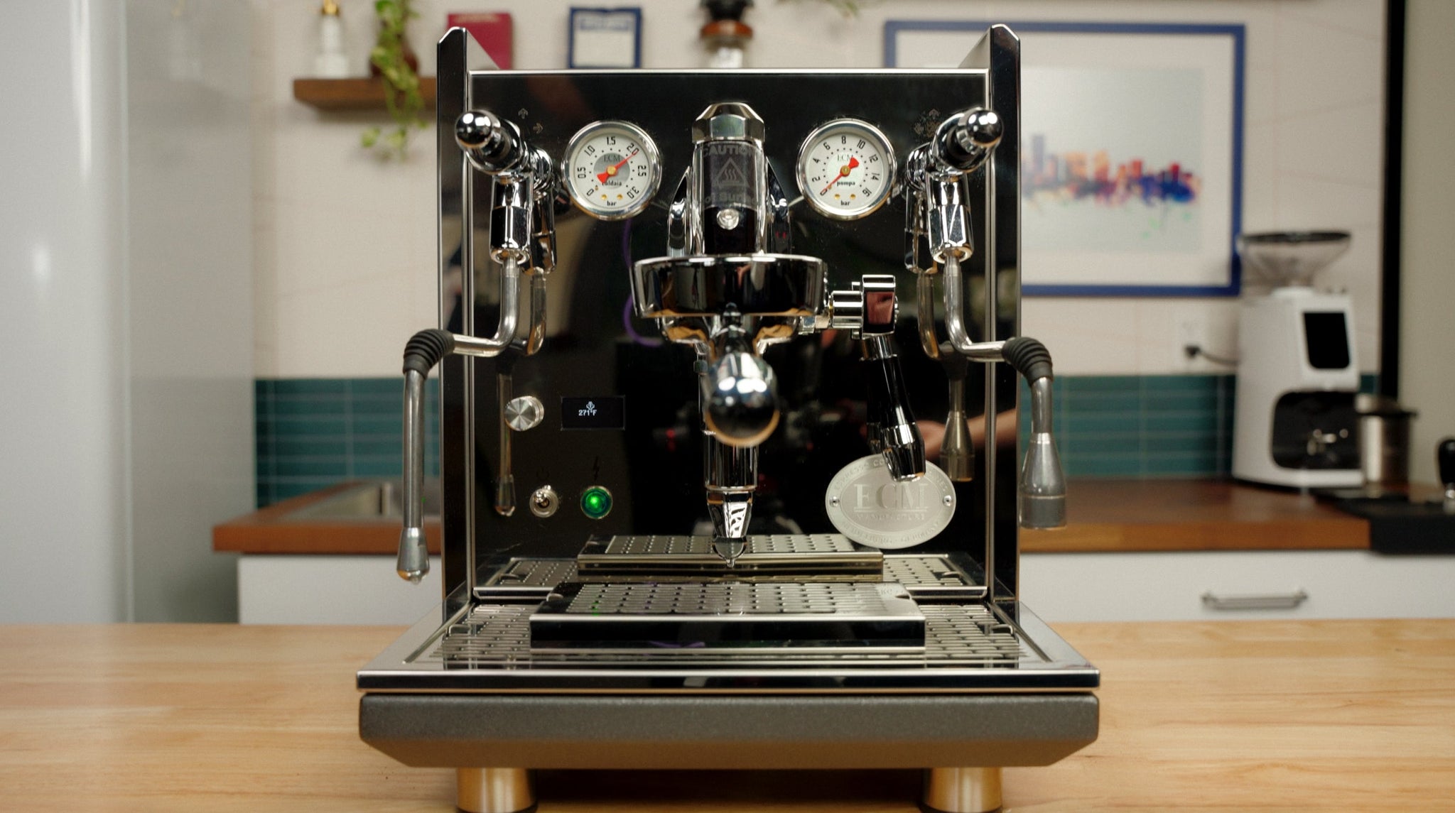 Dual group espresso machine with chrome finish and wood accents on a cafe counter.