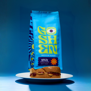 Blue Goshen Coffee Brazil Fazenda Frutas bag above a jam filled pastry on a white plate
