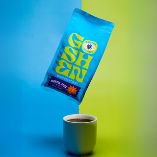 Mokha Java whole bean coffee bag in bright blue packaging with a yellow Goshen logo against a blue and lime backdrop