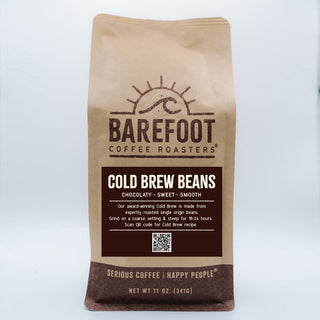 Brown kraft bag labeled Cold Brew Beans from Barefoot Coffee Roasters with logo.