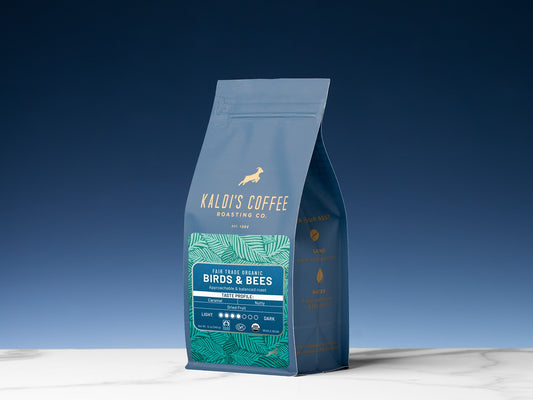 Blue Kaldi's Birds & Bees coffee bag photographed against a blue sky.