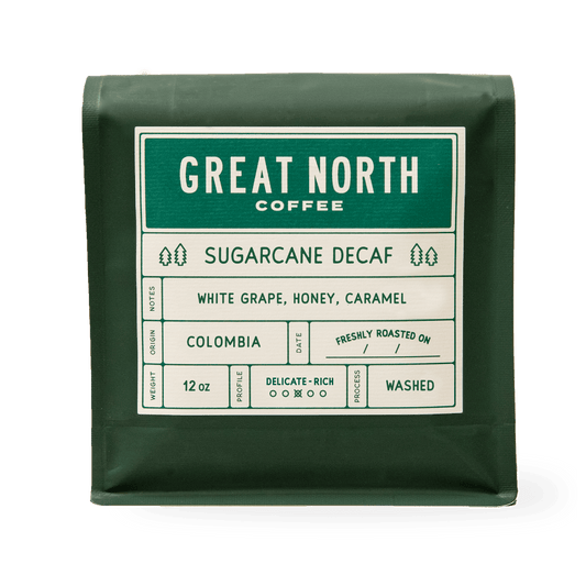 Green bag labeled Great North Coffee Sugarcane Decaf with Colombia origin details on a white label