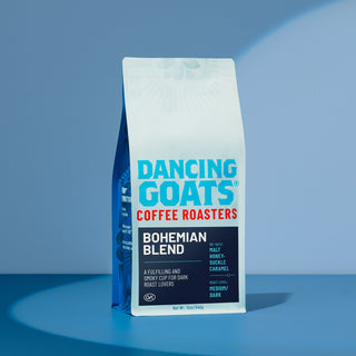 Dancing Goats coffee bag with bold blue logo on white packaging against a blue backdrop