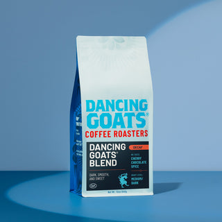 Dancing Goats decaf coffee bag against a clear blue sky.