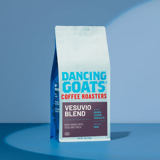 Front of Dancing Goats Vesuvio coffee bag showing Vesuvio Blend and COFFEE ROASTERS branding on a purple label