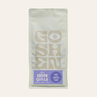 Close-up of Peru Abdon Quilla Ochochoque coffee bag with a pale front and a faded logo at the bottom