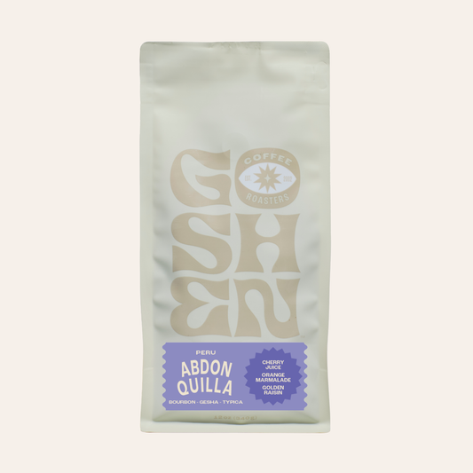 Close-up of Peru Abdon Quilla Ochochoque coffee bag with a pale front and a faded logo at the bottom