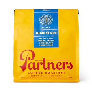 Jumpstart yellow coffee bag with blue label and Partners branding