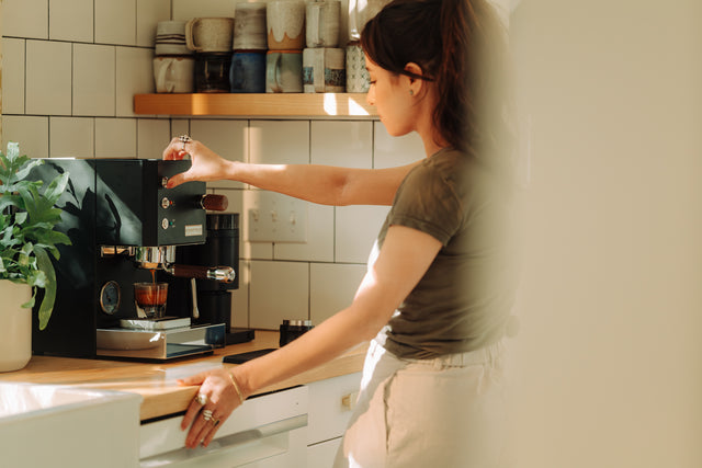 Profitec GO Espresso Machine, with Fellow Opus Grinder, Woman Pulling a Shot, from Clive Coffee, lifestyle, large
