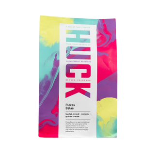 Flores Belas coffee bag with bright abstract colors and a white label on the front.