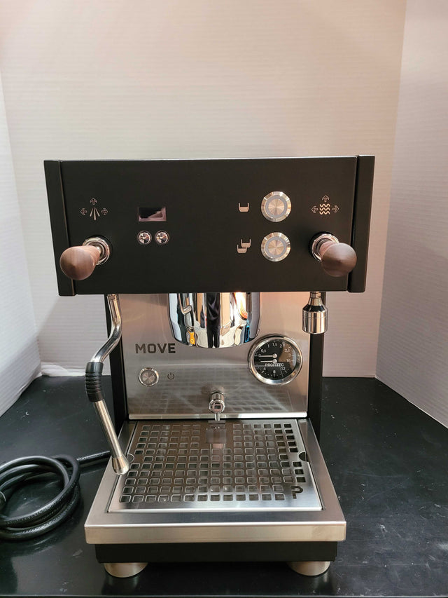 Front view of Open Box Profitec MOVE espresso machine with two wooden portafilter handles and chrome dials