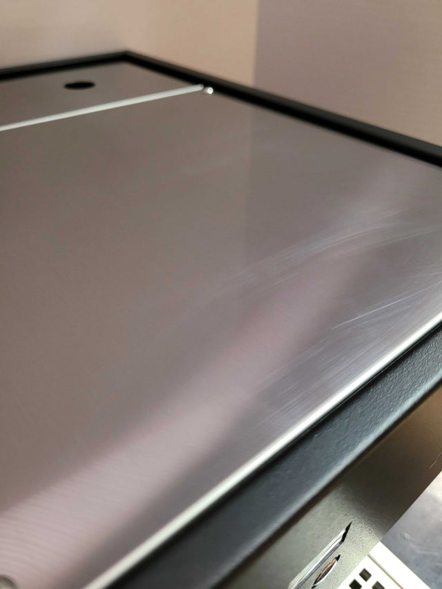 Brushed stainless steel top panel with a small circular cutout