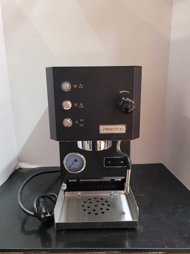 Open box Profitec GO espresso machine front view with gauge portafilter attached and chrome accents