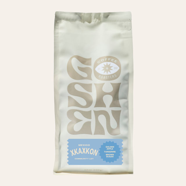 Partial view of a white XKAXKON coffee bag against a pale background