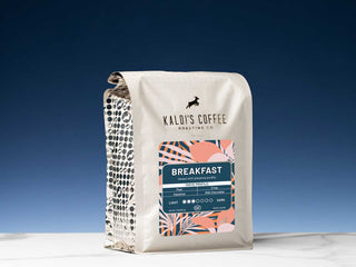 Kaldi's Breakfast Blend coffee bag with a colorful label against a deep blue background.