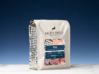 Close up of Kaldi's Coffee 700 bag against a dark blue sky, showing the curved top and patterned side panel.