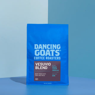 Dancing Goats coffee bag against a blue background with the large Dancing Goats logo