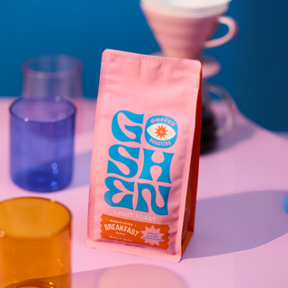 Pink Bright Eyed Breakfast coffee bag showing light roast label and orange flavor badge on the front