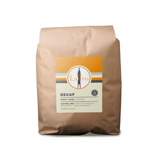 Ladro Decaf coffee bag from a side angle with brown kraft packaging and circular Ladro logo plus Swiss Water badge on the label
