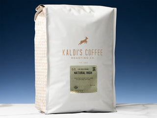 Kaldi's Natural High coffee bag in navy packaging with a gold label on the front