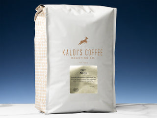 Close-up of Cafe Malta bag in dark blue packaging with a gold Malta label on the front.