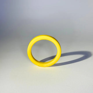 Bright yellow silicone gasket for E61 group head placed on a white background.
