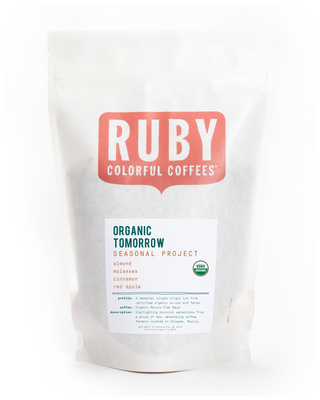 White coffee bag with a large red Ruby logo and Organic Tomorrow Seasonal Project label