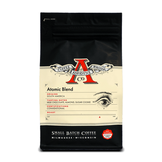 Atomic Blend packaging front with cream label and vintage style illustration and red emblem