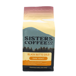 Black Butte Gold bag from Sisters Coffee Co featuring mountain and forest artwork with Dark Roast label