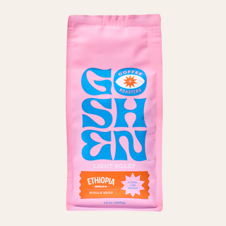 Pink Ethiopia Biruhi coffee bag with bold blue artwork on the front.