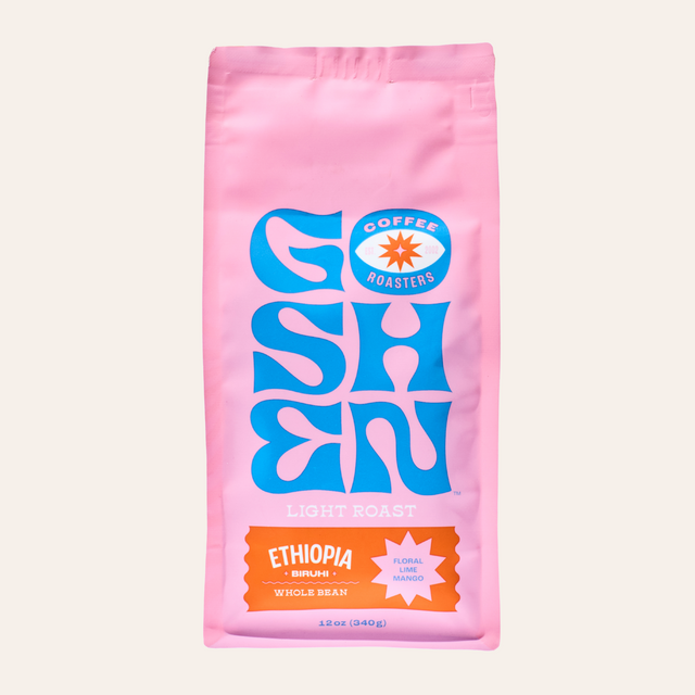 Pink Ethiopia Biruhi coffee bag with bold blue artwork on the front.