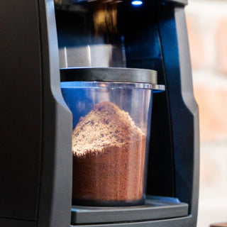 Baratza Encore ESP Pro coffee grinder with clear hopper filled with ground coffee