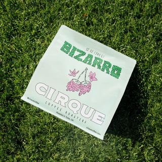 Cirque Coffee Roasters Bizarro bag on grass with orange packaging