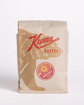Kuma Coffee Bright Blend bag showing purple badge and sunburst graphic