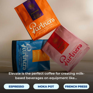 Three Partners coffee bags arranged diagonally Bedford orange Blue Flatiron and Elevate pink labels
