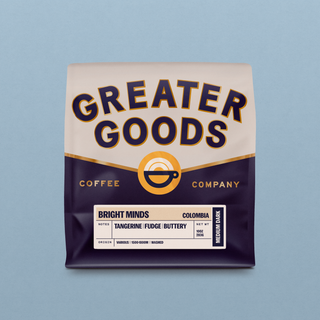 Close-up of Bright Minds Colombia coffee bag with cream label and bold navy lettering against a dark purple bottom section.