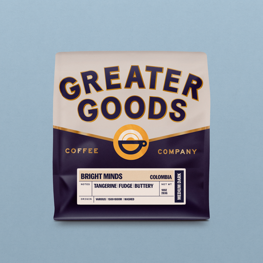 Close-up of Bright Minds Colombia coffee bag with cream label and bold navy lettering against a dark purple bottom section.